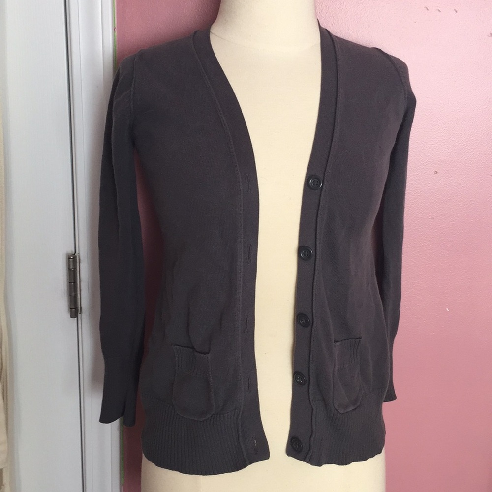 A dark gray button sweater